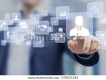 Human resources (HR) management concept on a virtual screen interface with a business person in background and icons about recruiting, technology, data, training Royalty-Free Stock Photo #574921243