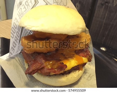 Hamburger with Cheddar cheese, bacon, onion rings and BBQ sauce.