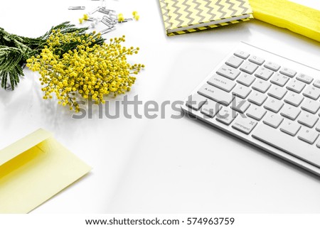 female desktop with keyboard and flowers close up