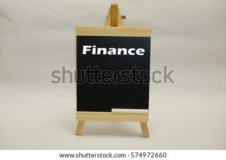 Word "Finance" written on mini chalkboard isolated on white