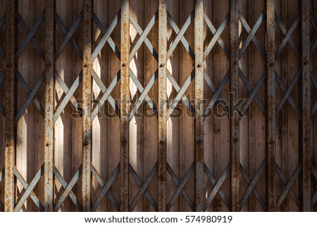 light and shade on old rusty metal folding door