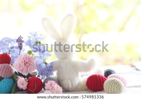 Rabbit doll with egg and flower ,Easter background