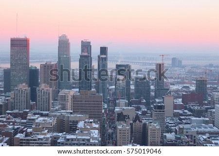 The view on Montreal city's skyscrapers and road, Quebec, Canada, from Mont Royal Chalet, evening in winter time, the Belt of Venus.