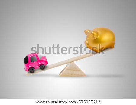 Concept about saving to buy the car with The piggy bank and car toy on seesaw