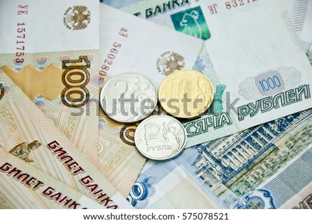 three different coins on a banknotes background