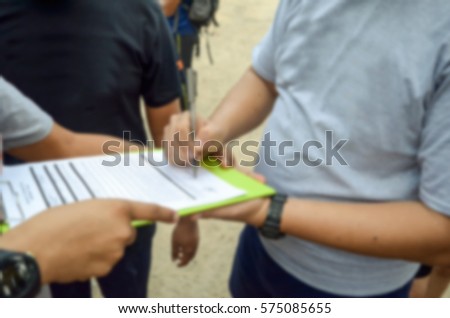 Blurred background abstract and can be illustration to article of unidentified tourist hand writing on document.