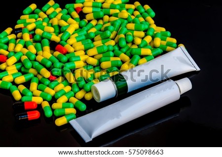 antibiotics & pills medicine & cream medicine on black background 