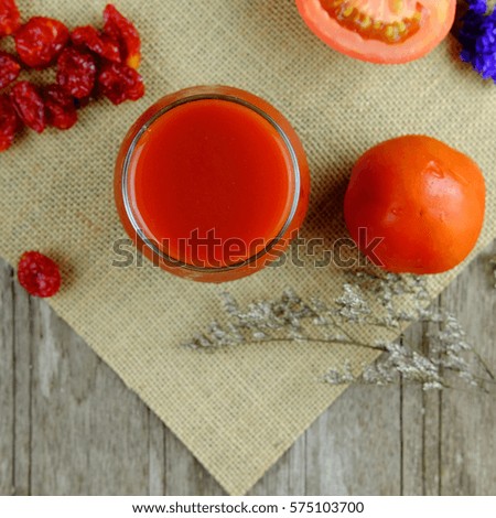 Top view of Healthy tomato juice in glass on wood table background, Healthy drink, selective focus and copy space.