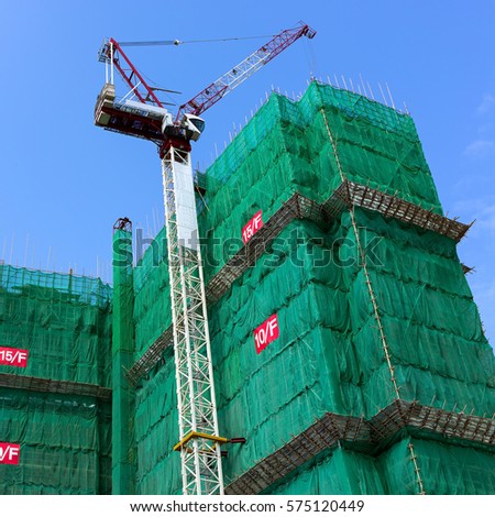 Construction site with crane and building on sky background
