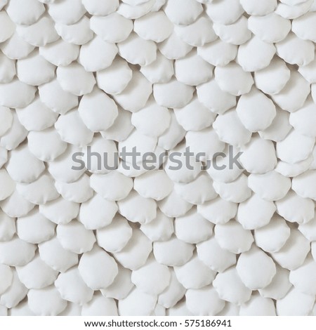 white background with soft hand made textile scales.
