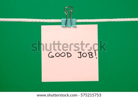 Pink paper sheet on the string with text Good Job over colorful background