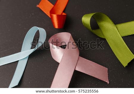 cancer awareness ribbon on black background