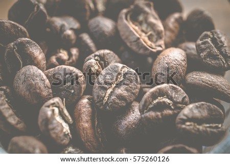 The macro of roasted coffee beans, can be used as background. Roasting coffee transforms the chemical and physical properties of green coffee beans into roasted coffee products.