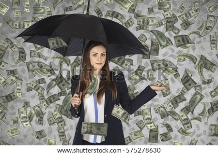 business woman hiding under an umbrella, falling money,