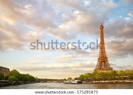 The Eiffel Tower and the river Seine at sunset sky background in Paris