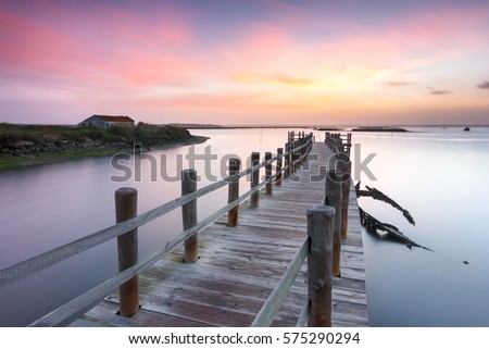 Abandoned boat and a ancient pier