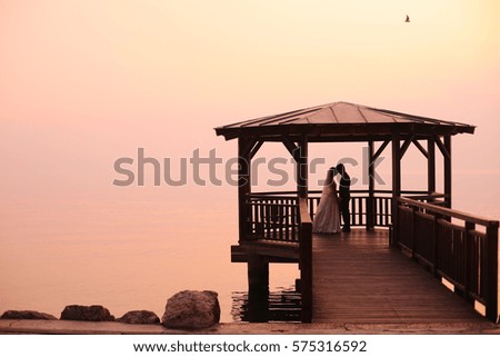 Bride and groom on wooden bridge
