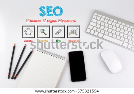 SEO concept. Office desk table with computer, Smartphone, note pad, pencils