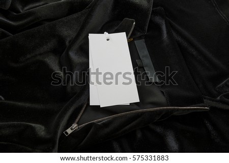Tags on a Black Velvet Dress with Silver Zipper