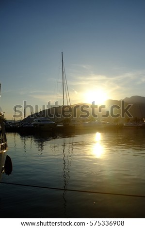 Sailing ships and yachts stand moored in Marina port at the sunset. Mediterranean coast,Tivat. Montenegro. Embankment of Tivat city