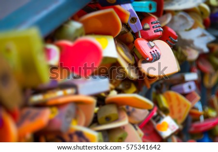 A love lock or love padlock is a padlock which sweethearts lock to a bridge , Valentine's Day ,selective focus