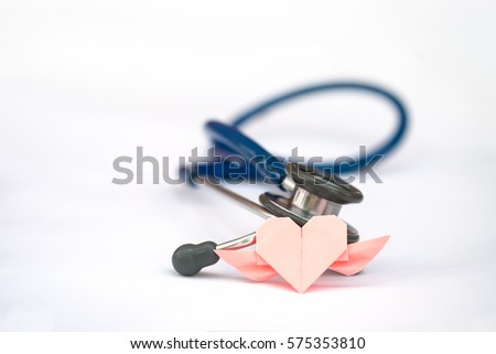 Pink paper heart and stethoscope on white background, concept of Valentine's day and healthcare Royalty-Free Stock Photo #575353810