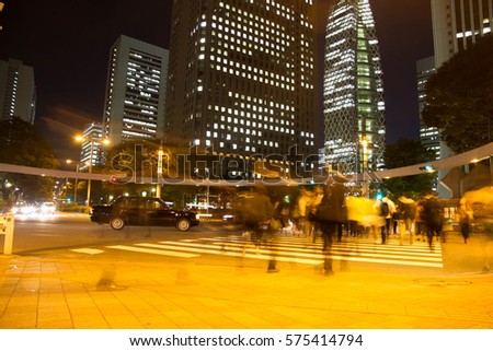 Shinjuku night Blurred light motion people walk on street in the city Japan