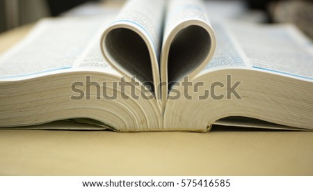 Book with opened pages and shape of heart