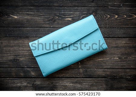 Blue leather wallet on wooden background top view