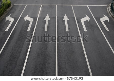 Arrow signs as road markings on a street with six lanes Royalty-Free Stock Photo #57543193