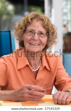 Elderly Woman Drinking Liqueur Outdoors