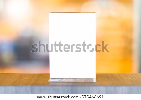 Mock up Menu frame in Bar restaurant ,Stand for booklets with white sheets of paper acrylic tent card on wooden table on