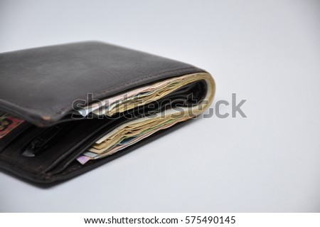 Leather black wallet on a light background 