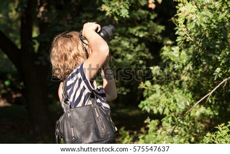 Woman photographer working in the park
