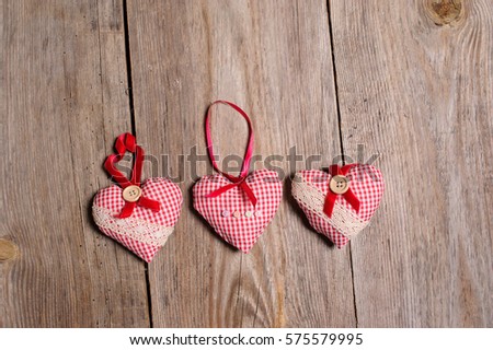 Hearts made of cloth on a wooden background. Valentines day. Valentines day greeting card.