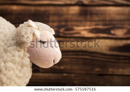the toy of white lamb face on wood Royalty-Free Stock Photo #575587516