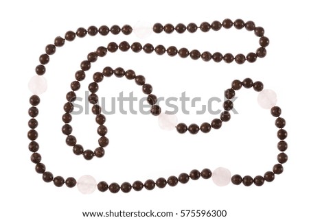 Close-up picture of a long woman's necklace made by plastic and wood -isolated on white.
