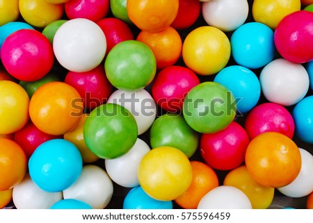 Bubble gum chewing gum texture. Rainbow multicolored gumballs chewing gums as background. Round sugar coated candy dragee bubblegum texture. Food photography. Colorful bubblegums wallpaper. Sweets.