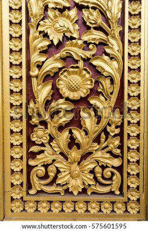 Carving Buddhism motifs in wood paint in gold and red color at Phnom Penh Royal Palace, Cambodia