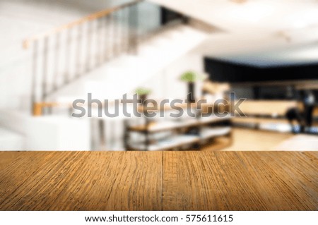 empty wooden table over blurred cafe 