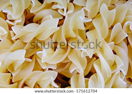Fusilli dry pasta background concept. Pasta texture for background uses. Swirled pasta pattern. Food photography in studio.