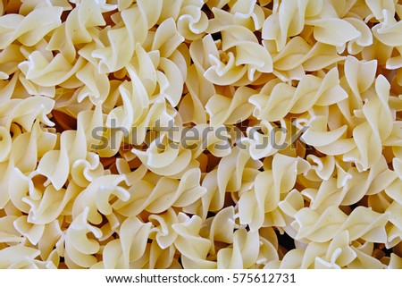 Fusilli dry pasta background concept. Pasta texture for background uses. Swirled pasta pattern. Food photography in studio.