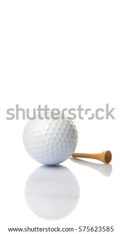 Golf ball and wooden tee over white background