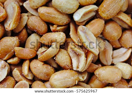 Peeled peanuts background food photography in studio. Close up macro peanuts photo. Beautiful salted roasted peanuts pattern concept. Nuts texture.