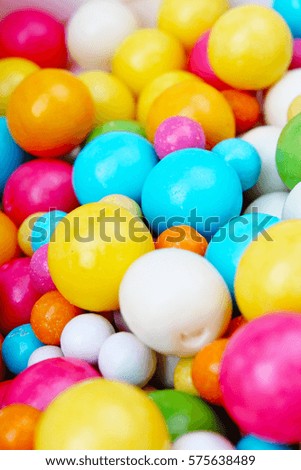 Shiny sugar coated round chocolate balls as background. Candy bonbons multicolored texture. Round candies sweets pattern concept. Food photo studio photography. Candy background.