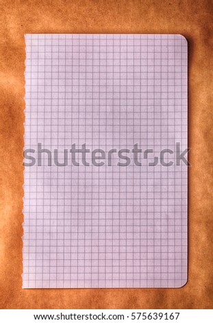 Square checkered paper on old craft paper background 