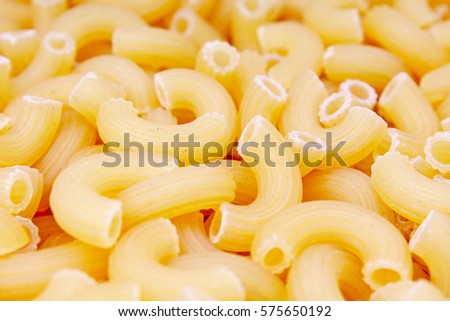 Macaroni dry pasta background concept. Pasta texture for background uses. Swirled pasta pattern. Food photography in studio.