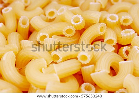 Macaroni dry pasta background concept. Pasta texture for background uses. Swirled pasta pattern. Food photography in studio.