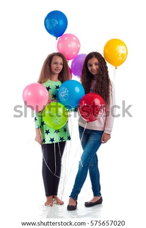 Two young girls with long hair girlfriend with balloons on a white background