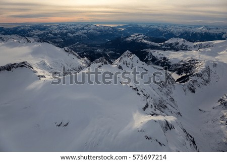 Aerial view of Mamquam Mountain covered in snow. Picture taken in British Columbia, Canada, during a cloudy winter evening.